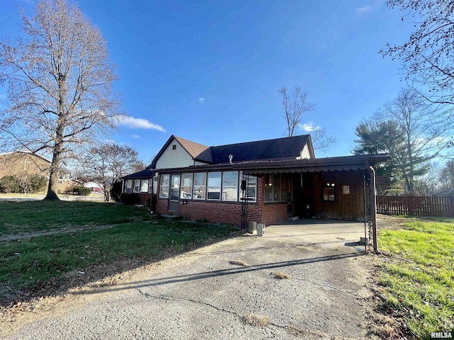 view of front facade with a front yard and a carport