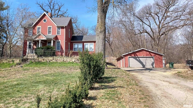 view of front of house with an outdoor structure, a front lawn, and a garage