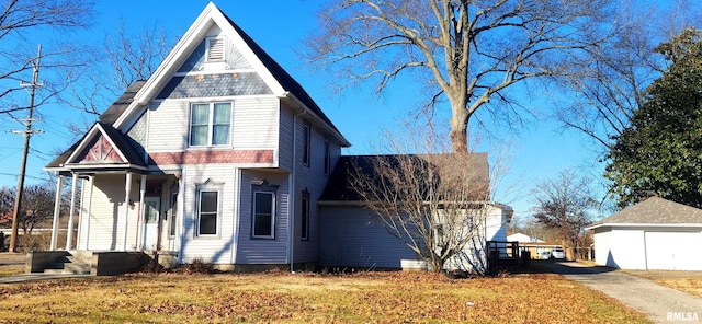 exterior space featuring a front yard, covered porch, and a garage