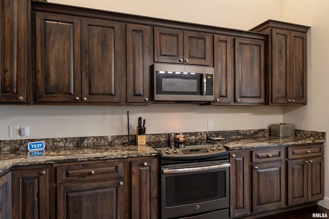 kitchen with dark stone counters, dark brown cabinets, and appliances with stainless steel finishes