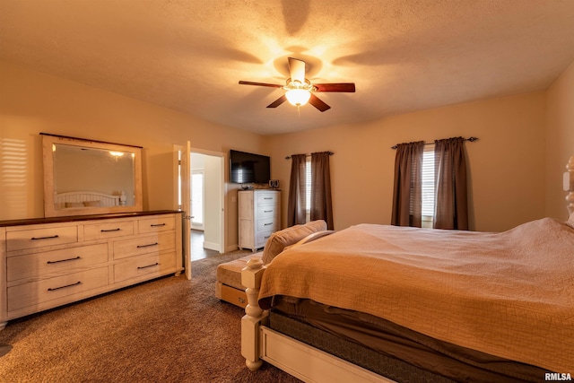 bedroom featuring ceiling fan and dark carpet