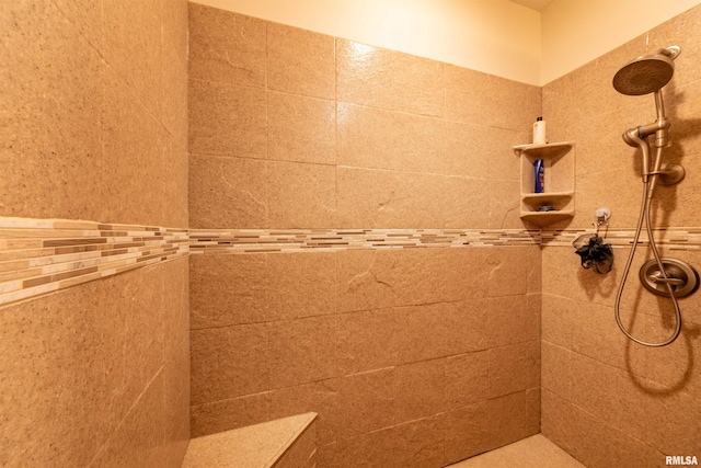 bathroom with a tile shower