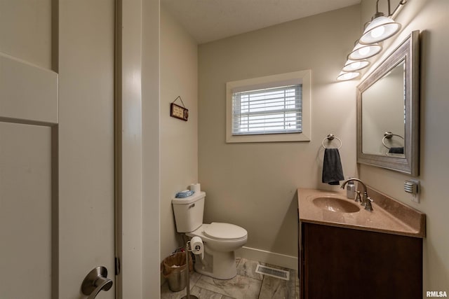 bathroom with a textured ceiling, toilet, large vanity, and tile floors