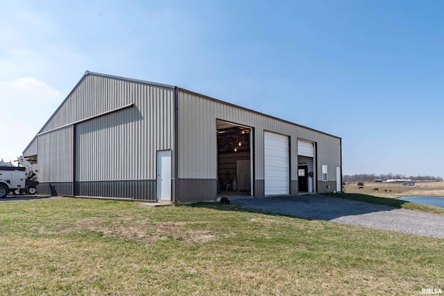 view of shed / structure featuring a lawn and a garage