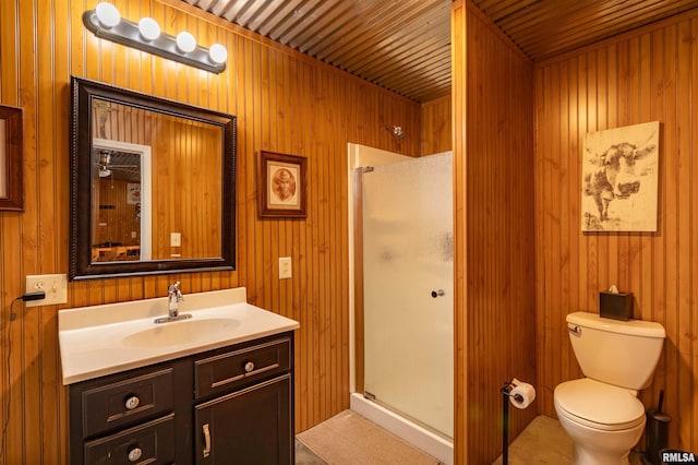 bathroom with toilet, wood walls, and vanity