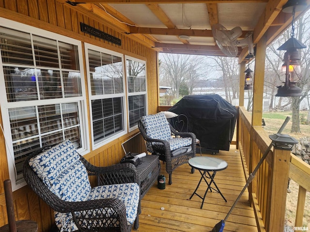 wooden deck featuring an outdoor living space and a grill