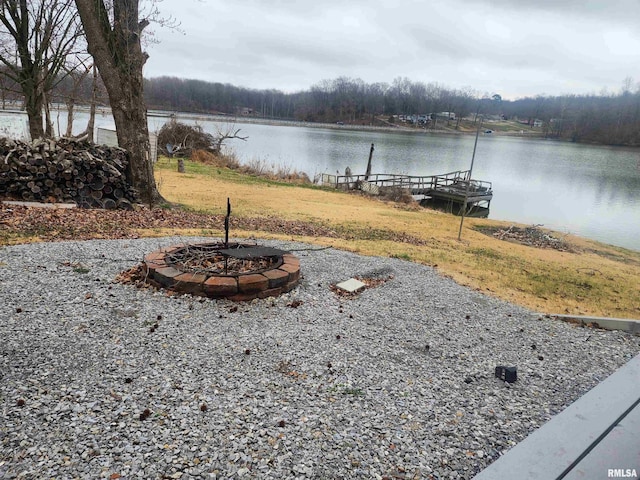 view of yard with a water view and an outdoor fire pit