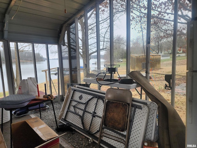 sunroom / solarium featuring plenty of natural light and a water view