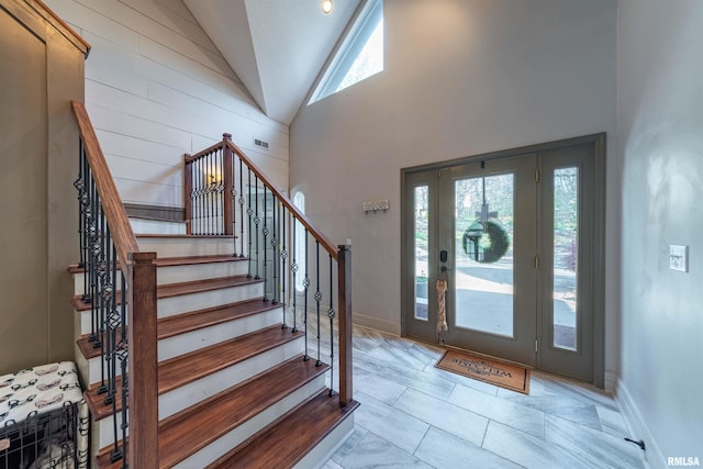 tiled entrance foyer with high vaulted ceiling