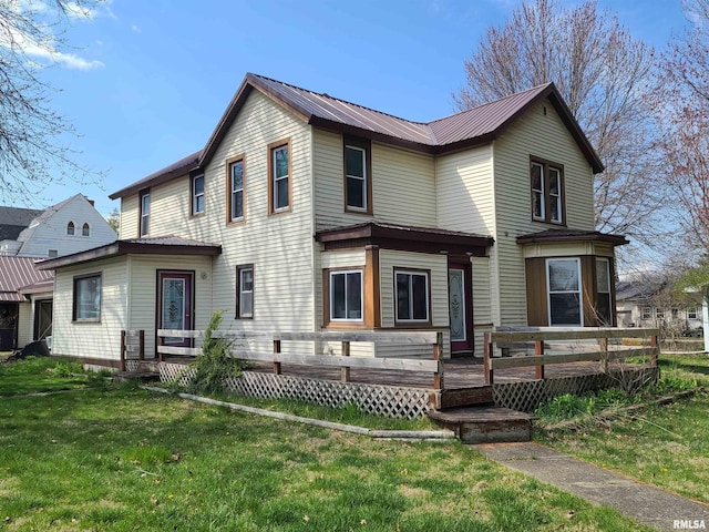 back of house featuring a deck and a lawn