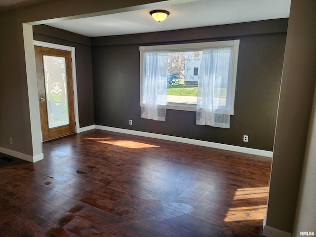 empty room with dark hardwood / wood-style floors