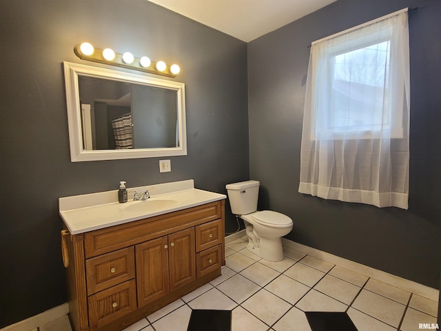 bathroom featuring toilet, vanity, and tile patterned floors