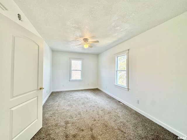 carpeted empty room with a textured ceiling and ceiling fan