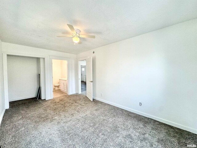 unfurnished bedroom featuring ceiling fan, carpet floors, ensuite bathroom, and a textured ceiling