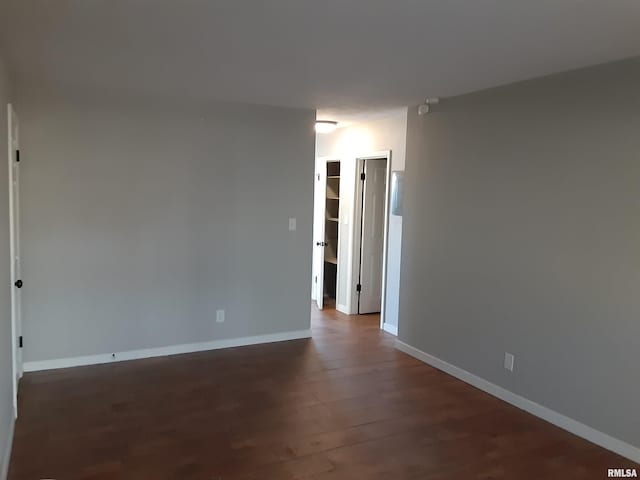 spare room with dark wood-type flooring