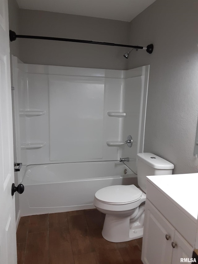 full bathroom featuring wood-type flooring, vanity, shower / bathtub combination, and toilet