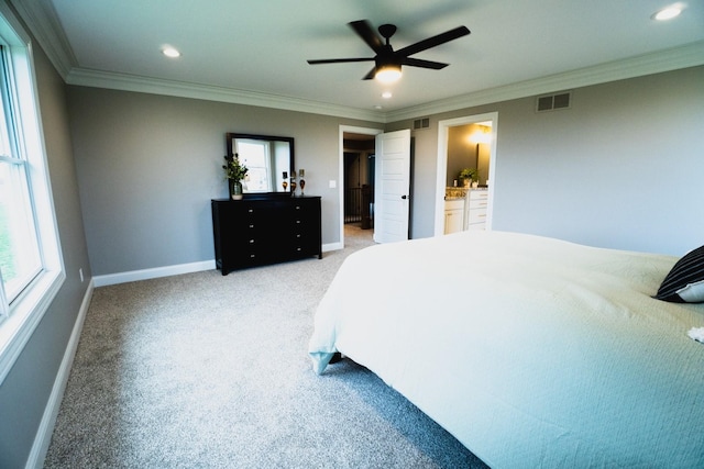 carpeted bedroom featuring connected bathroom, ceiling fan, and crown molding