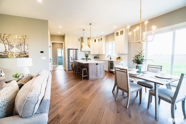 dining room with sink and dark wood-type flooring