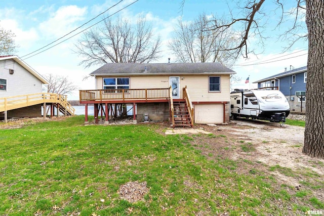 back of property with a deck and a yard