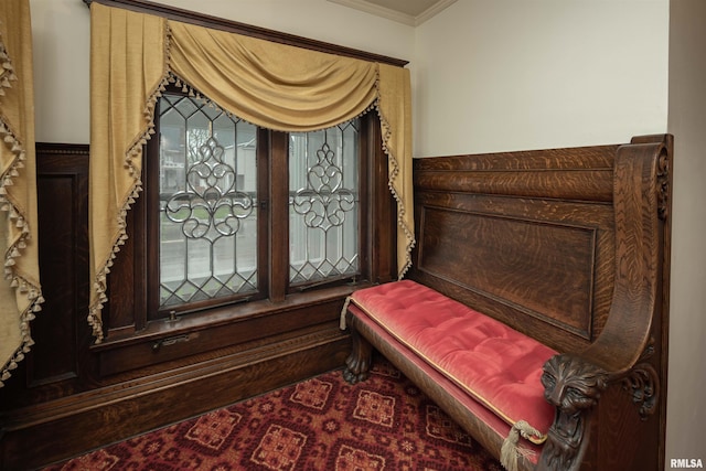 living area featuring crown molding