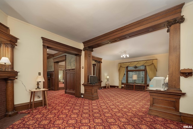 interior space with ornamental molding, radiator, and decorative columns