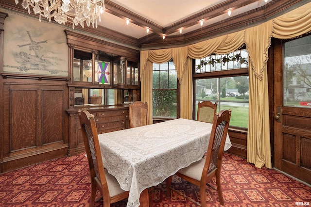 dining room featuring beamed ceiling, dark wood-type flooring, a notable chandelier, and ornamental molding