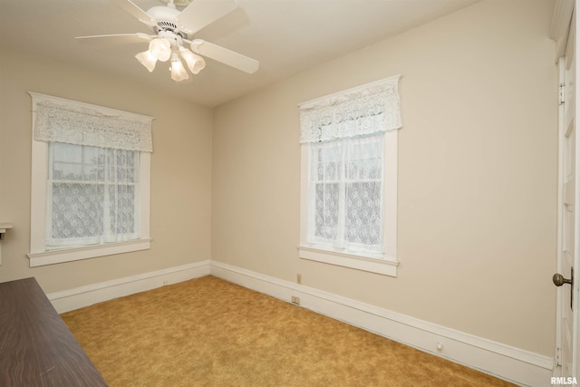 carpeted spare room with ceiling fan