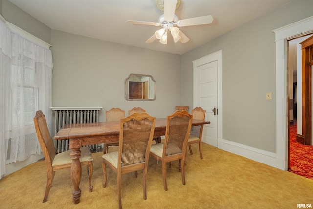 dining area with light colored carpet and ceiling fan