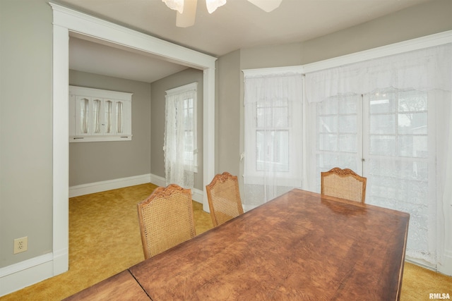 carpeted dining space featuring ceiling fan