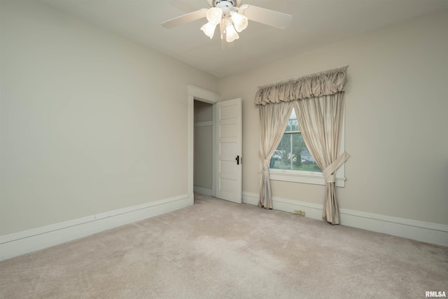 empty room with ceiling fan and carpet