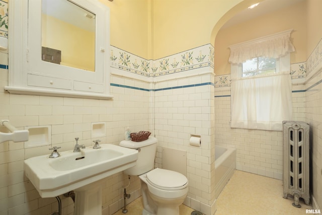 full bathroom with backsplash, toilet, radiator heating unit, and tile walls