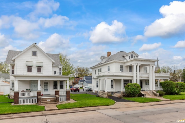 view of front facade featuring covered porch and a front yard