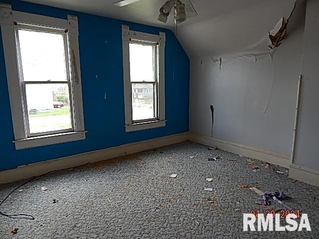 bonus room with baseboards, vaulted ceiling, and a ceiling fan