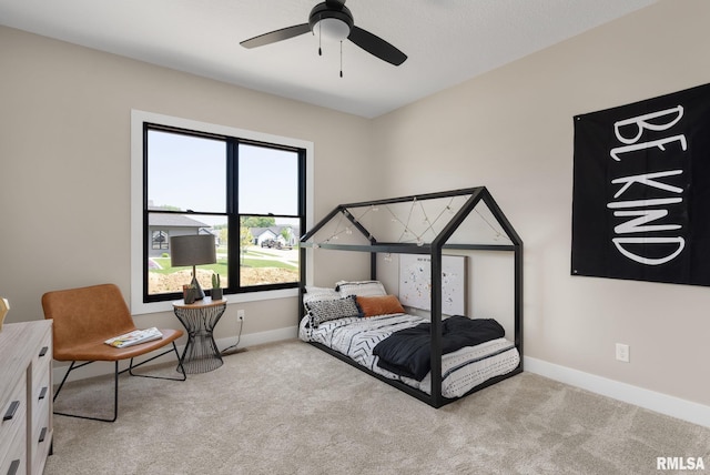 bedroom featuring ceiling fan and light carpet