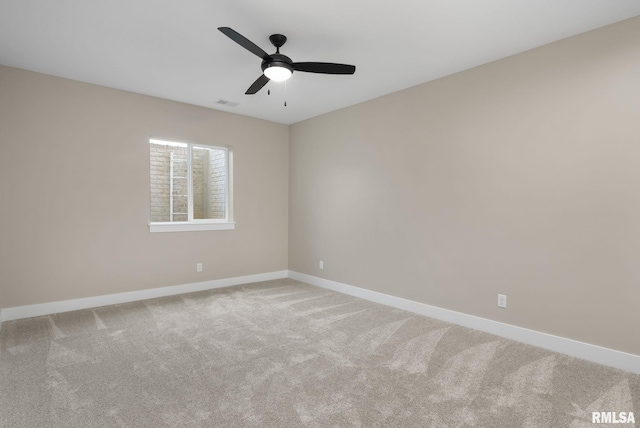 spare room featuring carpet flooring and ceiling fan