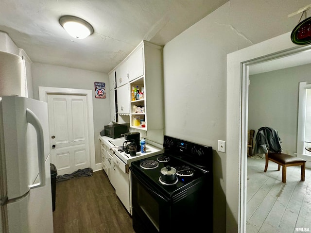 kitchen featuring white refrigerator, white cabinetry, black electric range oven, and dark hardwood / wood-style floors