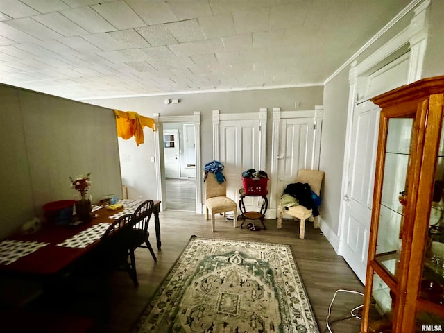 dining area featuring hardwood / wood-style floors and crown molding