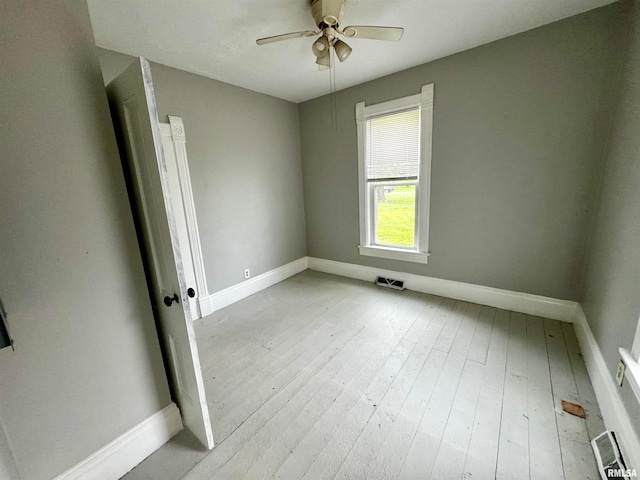 spare room featuring hardwood / wood-style flooring and ceiling fan