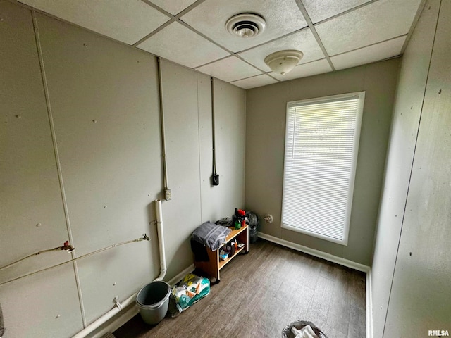 miscellaneous room featuring wood-type flooring and a paneled ceiling