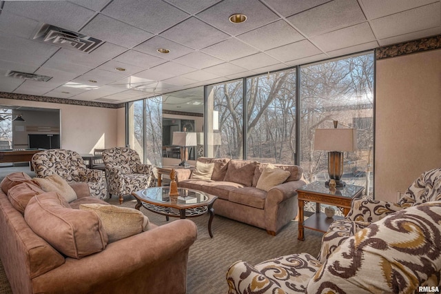 living room featuring floor to ceiling windows, carpet floors, and a paneled ceiling