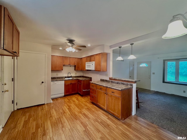 kitchen with ceiling fan, hanging light fixtures, white appliances, sink, and light colored carpet