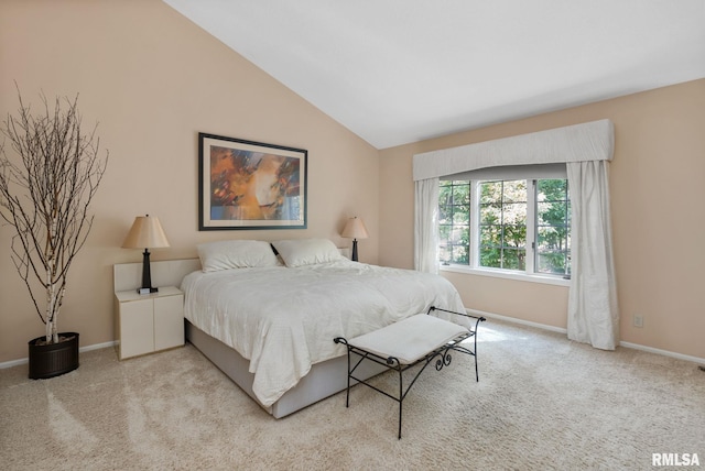 bedroom featuring light carpet and vaulted ceiling