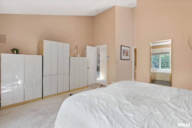 carpeted bedroom featuring high vaulted ceiling