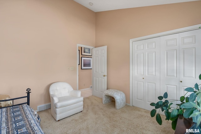 carpeted bedroom featuring high vaulted ceiling and a closet