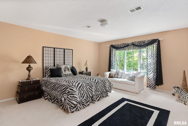 bedroom with carpet flooring and a textured ceiling