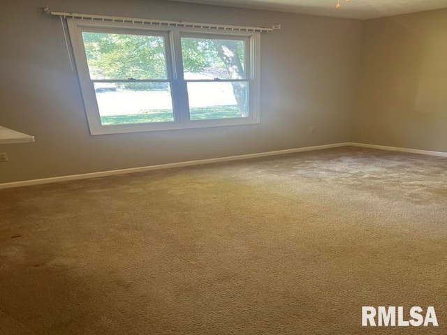 carpeted empty room with ceiling fan and plenty of natural light