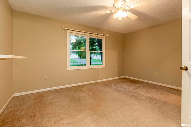 unfurnished room featuring carpet floors, ceiling fan, and a textured ceiling