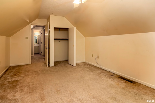 bonus room featuring vaulted ceiling, carpet flooring, and ceiling fan