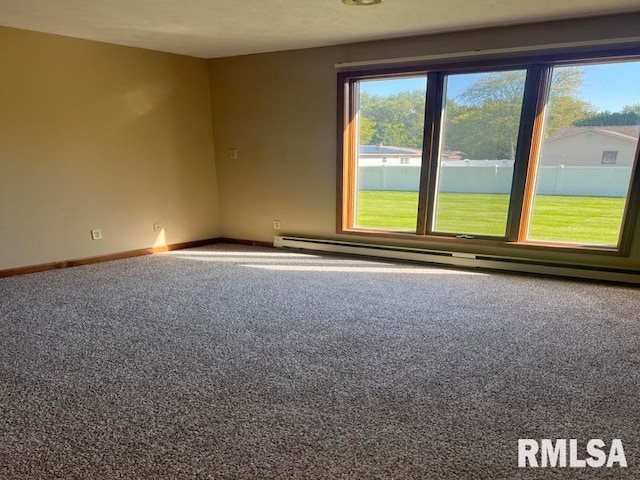 spare room with carpet and baseboard heating