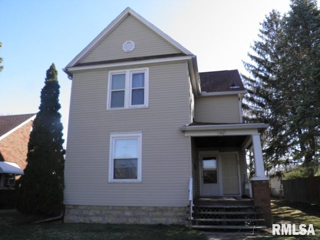 view of front of home featuring fence